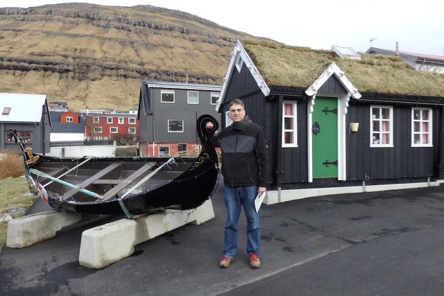 Old vikingy boat and house with sod roof