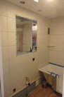 Tiling continues, medicine cabinet installed